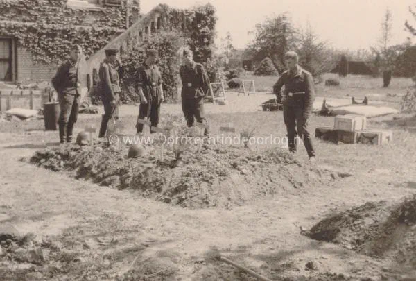 8. Duitse militairen poseren bij de veldgraven van de Nederlandse slachtoffers bij villa Amstelwijck in mei 1940. image